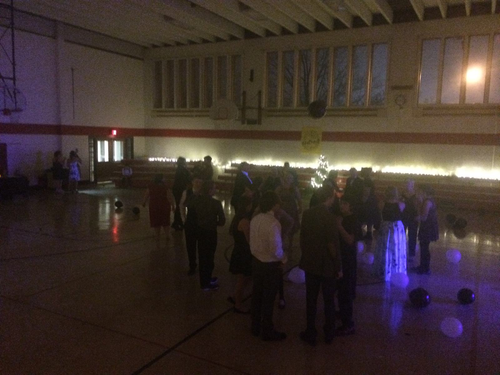 A school gym strung with lights, set up for a camp dance